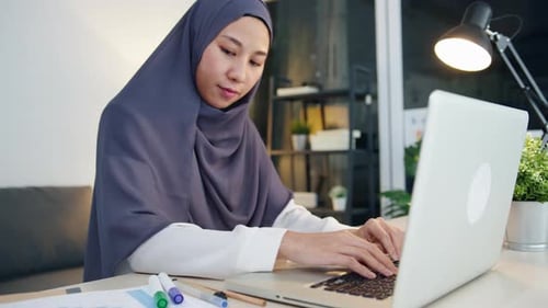 Woman Works on Laptop at Desk at Home