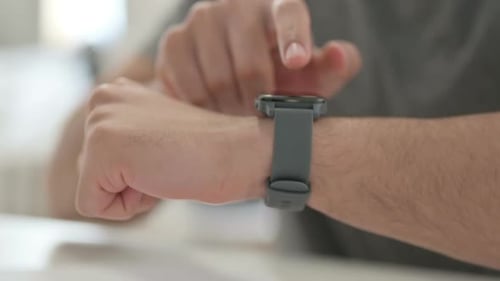 Hands of Young Man Using Smartwatch Close Up