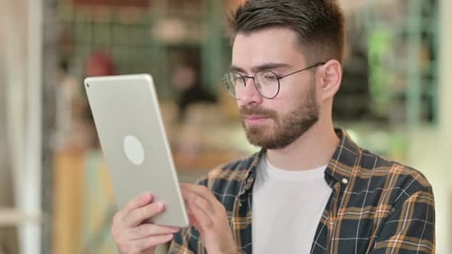 Young Adult Using Tablet Close Up Indoors