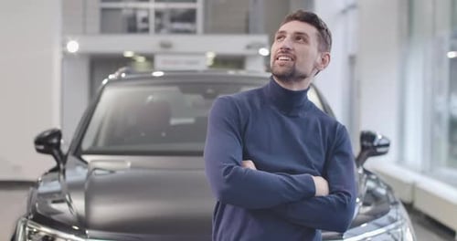 Close-up Portrait of Satisfied Caucasian Man Standing in Front of New Black Car