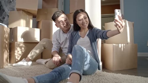 Couple Takes Selfie Amidst Moving Boxes at Home