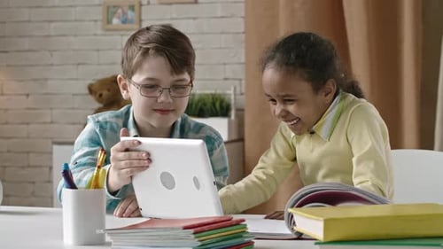 Children Enjoying Tablet Together at Table