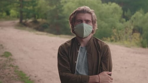 Portrait Of Man In Face Mask In Forest