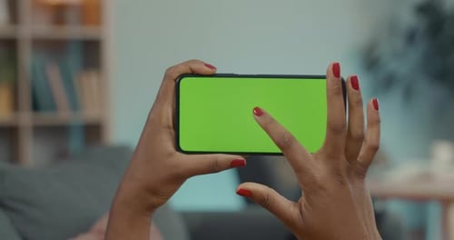 African American Woman Tapping on Chroma Key Screen of Cell Phone
