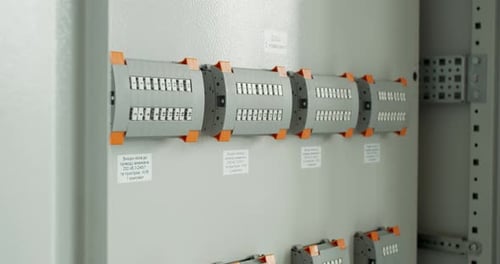 Technician Is Taking Apart a Control Panel Worker at the Factory Fixing