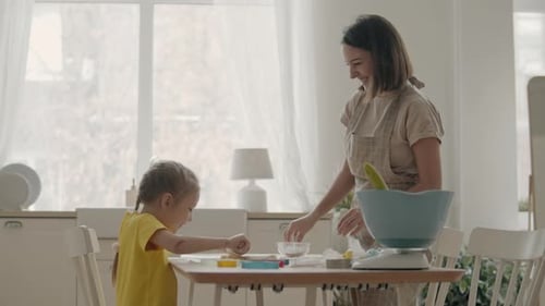 Mother and Daughter Baking Together in Bright Kitchen