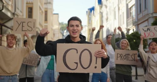 Young Adults Protesting and Marching in City