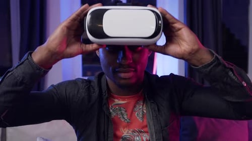 Man Smiling While Wearing VR Headset Indoors