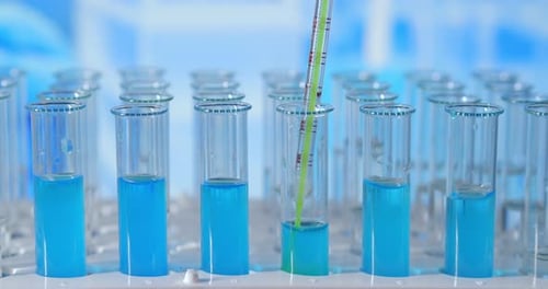 Adding Green Solution to Blue Liquid in Test Tube