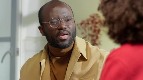 Man Talking to Woman Indoors