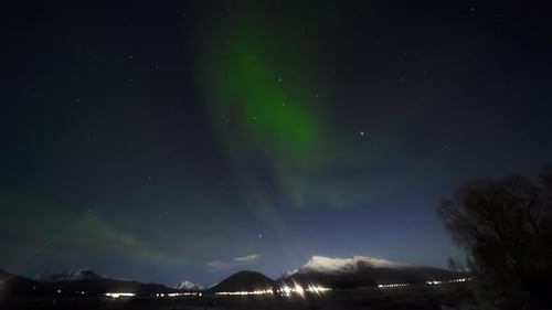 Timelapse of Northern Lights Dancing in the Sky As Seen From the Snowy Mountains