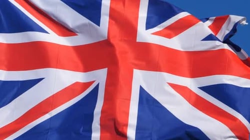 British Flag Waving Proudly Against Blue Sky