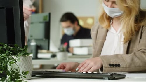 Young Blonde Woman Wearing Medical Mask Working in Office Businesswoman Signing the Documents