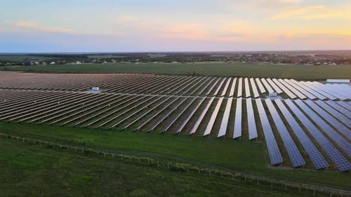 Aerial View of Large Solar Panels at a Solar Farm at Bright Summer Sunset. Solar Cell Power Plants