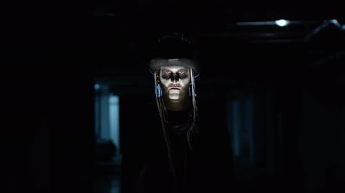 Creepy Man with Skeleton Makeup Appearing From Darkness When Light Falls on Him, Making Faces