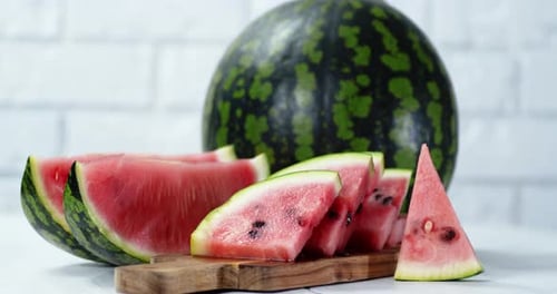 Pieces of Fresh Watermelon on Cutting Board Slowly Rotate.
