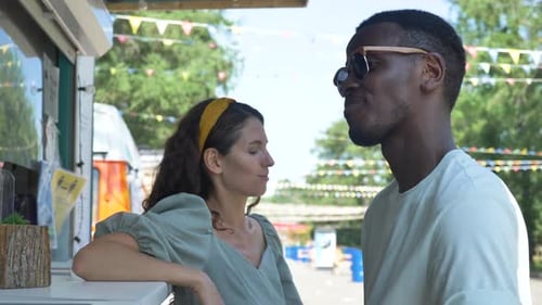 Young Adults Chatting at a Food Stand