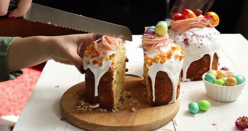 Decorated Easter Cake Being Sliced with Knife