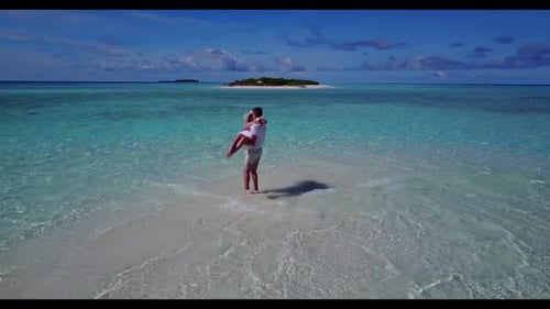 Young couple relax on paradise bay beach wildlife by turquoise water with white sandy background of