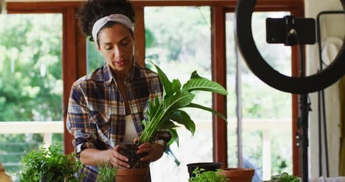 Woman Plants Plants Recording Vlog at Home