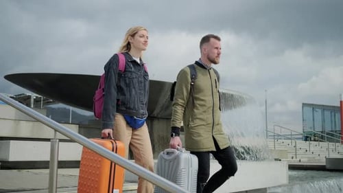 Young Couple Leaving Airport with Baggage