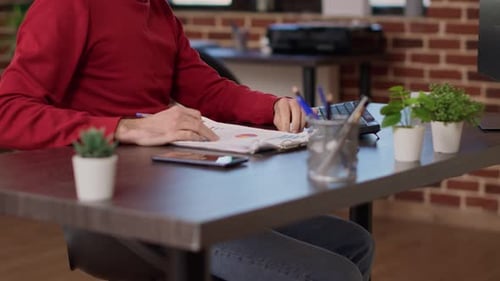 Male Employee Analyzing Business Charts on Documents