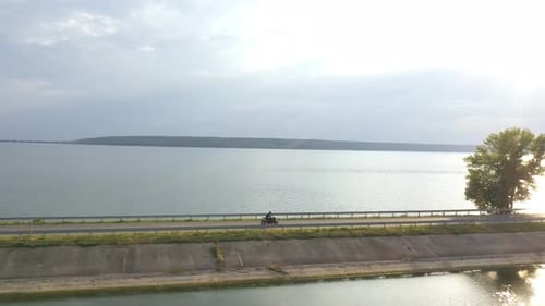 Motorcyclist Racing His Motorcycle on Dam Route