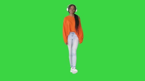 Smiling African American Woman Headphones Walking Listening To Music Green Screen Chroma Key
