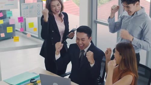 Excited Team Celebrates Success in Modern Office