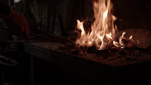 Forge Fire Burns Brightly in Blacksmith Workshop