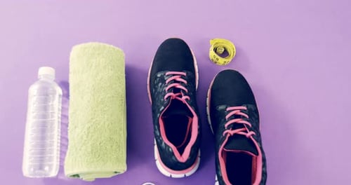 Workout Equipment Arranged Neatly on Purple Surface