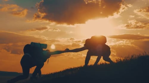 Silhouette of the Team on the Peak of Mountain. Sport and Active Life of People. Teamwork Assistance