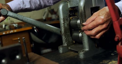 Goldsmith working on machine in workshop 4k