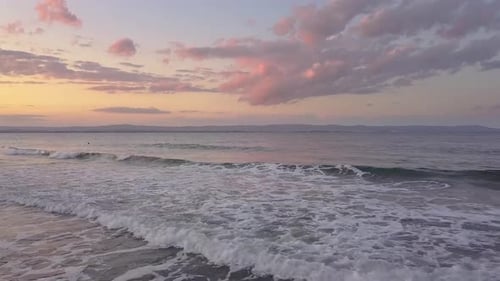 Aerial View of a Sea Surface with Blue Water Waves Under Sunset Sky
