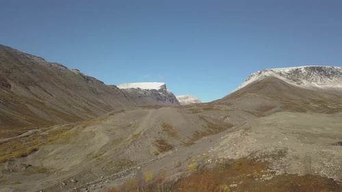 Aerial View Of The Mountainous Terrain Around There Is Snow On Top Of The Mountains