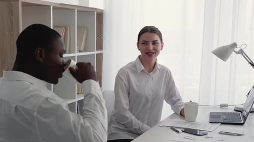 Coworkers Chatting in Bright Modern Office