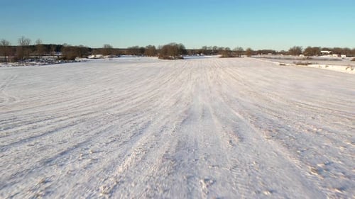 Aircraft flying above snowy field in Sweden