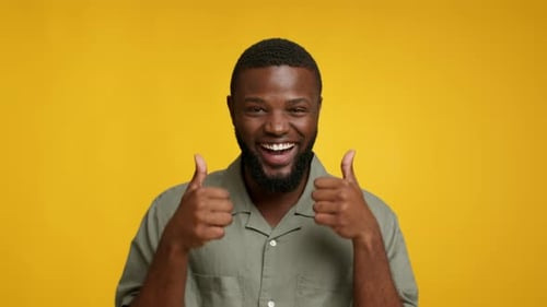 Man Gives Two Thumbs Up With a Big Smile