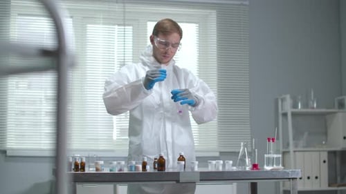Man in Protective Workwear and Gloves Who Work with Chemicals in the Laboratory