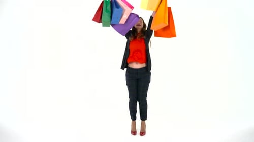 Female Shopper Holding Multicolored Shopping Bags on White Background in Studio
