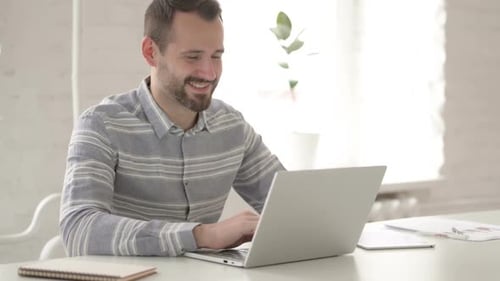 Young Adult on Video Call at Desk