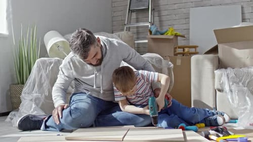 Father and Son Assembling Furniture Together