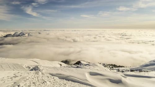 Snowy Mountains Above Ethereal Blanket of Clouds