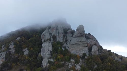 Mountains with Rocky Sculptures That are Getting Covered By Clouds