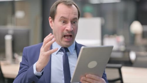 Portrait of Businessman Having Loss on Tablet in Office