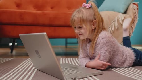 Joyful School Kid Girl Use Laptop Computer Learning Reading Online Education Lessons Alone at Home