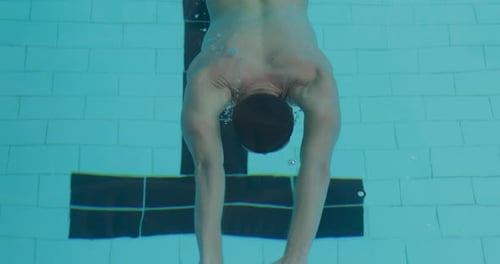 Swimmer swimming into the pool