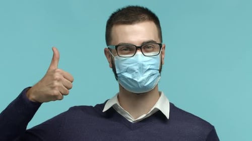 Enthusiastic Man with Mask Giving Thumbs Up