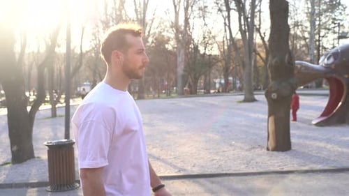 Young man walking in the park.