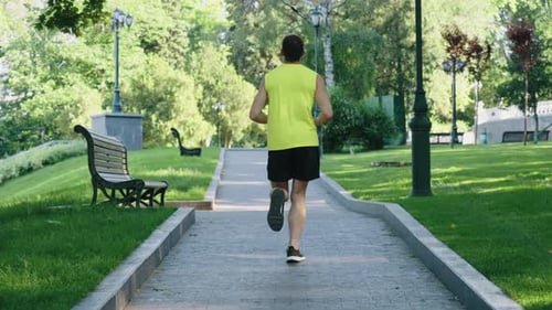 Jogger Running in Summer Park in Slow Motion